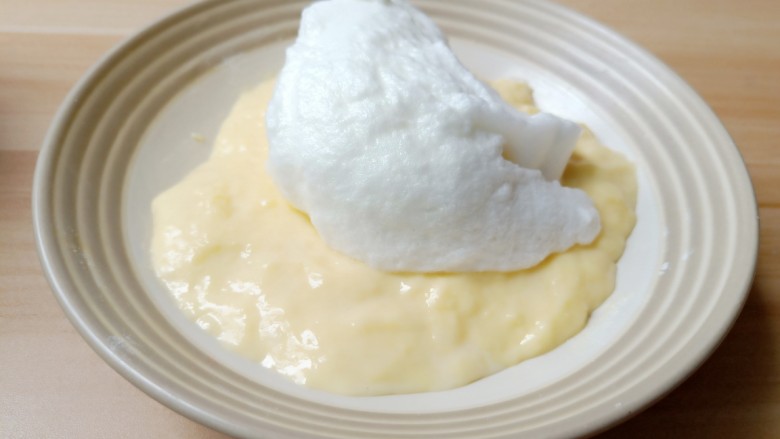 无油版原味松饼,取1/3的蛋清白霜加入面糊中，用翻拌的手法拌均匀。