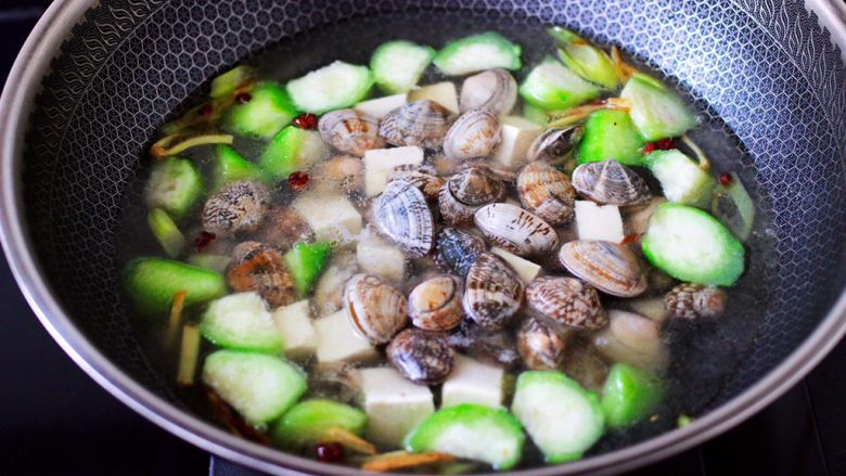 丝瓜花蛤炖豆腐,再放入洗净的花蛤。