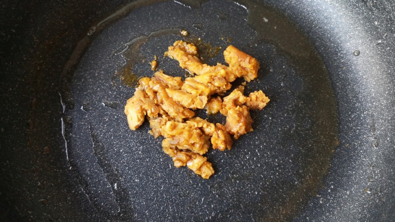 咸蛋黄鸡翅,锅中油倒出，留一点底油，放入咸蛋黄。