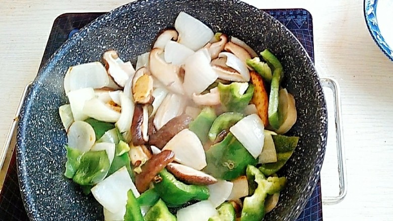 下饭神器黄焖鸡,锅中放入葱姜蒜，加入准备好的蔬菜煸炒。