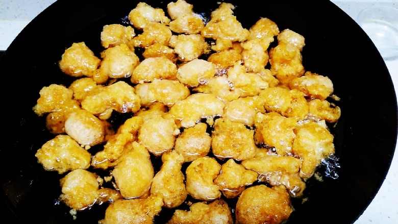 糖油酥脆糯米疙瘩,油温3层热放入锅中，小火炸制小剂子变成金黄色。
