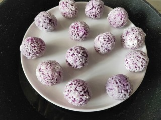 奶香紫薯糯米球,做好的紫薯球放在盘子中。