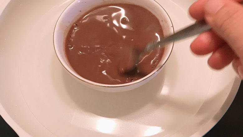 巧克力慕斯蛋糕,用叉子搅拌均匀，让吉利丁片充分融化。