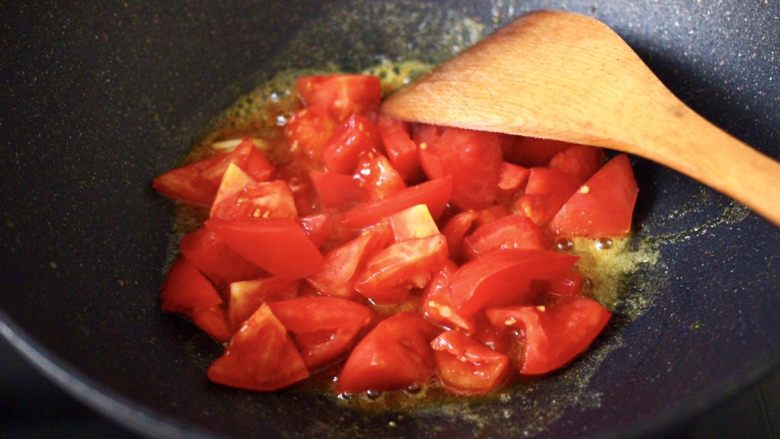 咖喱番茄丸子盖浇饭,放入番茄块，大火快速进行翻炒片刻。