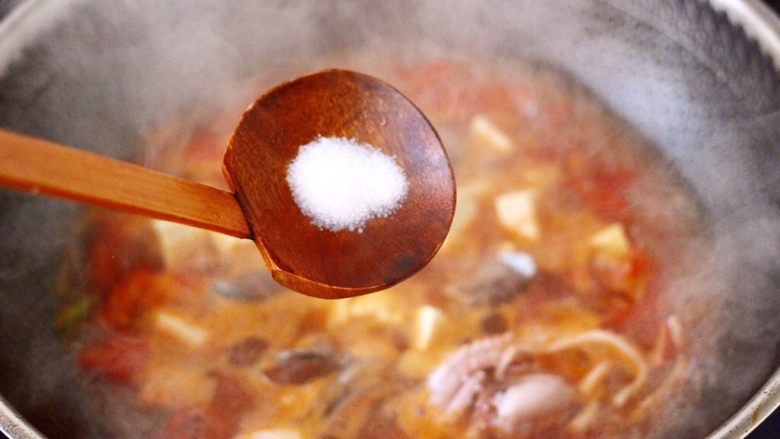 鲍鱼番茄海鲜豆腐浓汤,看见锅中汤汁变得越来越浓稠，放入适量的盐调味。