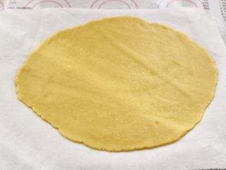 KT黄油蛋黄饼干,把面团用擀面杖擀成薄片，用油纸包好，放入冰箱冷藏30分钟。
