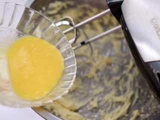KT黄油蛋黄饼干,分次加入蛋黄液，继续用打蛋器搅打均匀。