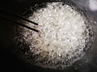 柚皮糖,中火煮开后转小火，一边煮一边用筷子慢慢轻搅动加速冰糖融化，直至糖浆起密集的大泡。
