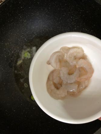 海鲜疙瘩汤,锅中放入食用油，葱花爆锅，放入虾仁翻炒；