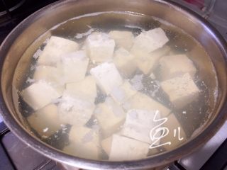 咸蛋黄豆腐,锅中烧开水，放入豆腐块焯水1分钟
