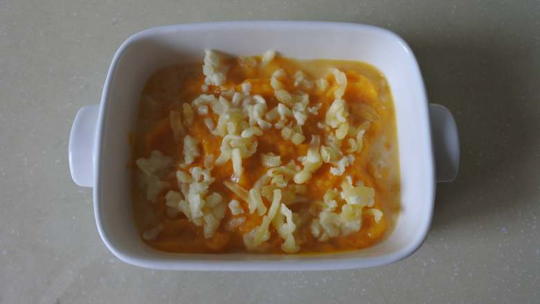 冬日暖心菜-奶香焗南瓜泥,装入烤碗内，铺平，铺上马苏里拉奶酪碎