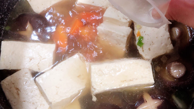 海鲜豆腐煲,煮开锅后，放入一个骨汤浓汤宝。盖盖儿小火儿炖煮5分钟。
