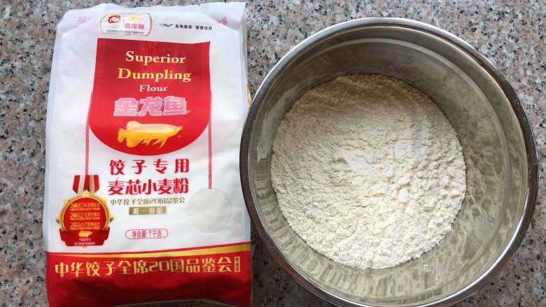 四喜蒸饺,金龙鱼饺子专用麦芯小麦粉倒入较大的容器里。
 
