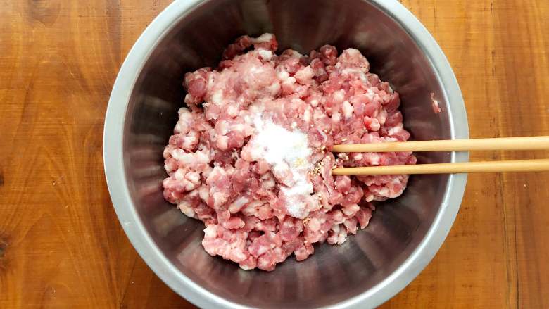 四喜蒸饺,醒面团的过程中，来调制饺子馅。首先在肉馅里加入盐，使劲朝一个方向搅拌，直至搅拌至肉上劲。
 