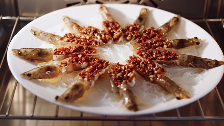金蒜粉丝蒸海虾,把盘子放入蒸箱里，开启嫩蒸模式蒸10-15分钟。