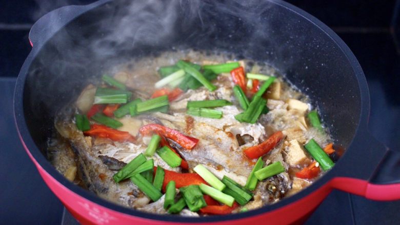 鲳鱼烧冻豆腐,放入红辣椒条，大火煮沸后，看见红椒变色断生，撒上韭菜段。