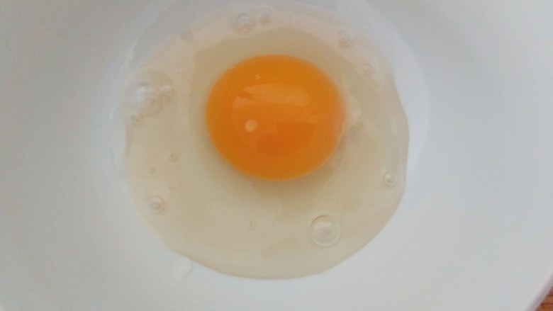 鸡蛋炒年糕,鸡蛋一个打入碗中搅拌均匀。