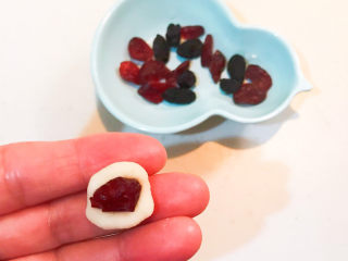 红豆汤圆,取一个小面坯压扁，加入一粒蔓越莓果干