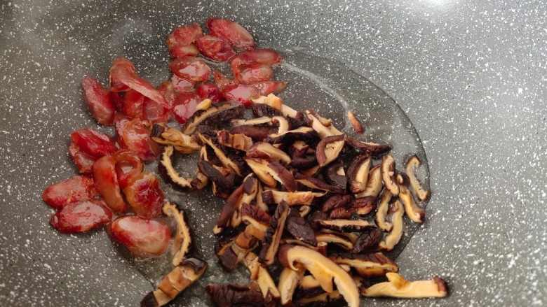香菇腊肠焖饭,放入香菇和腊肠炒香