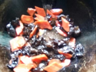 胡萝卜炒木耳,炒锅倒油，放入木耳和红萝卜大火煮。