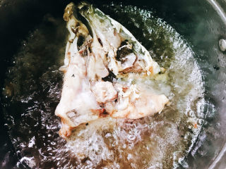 鱼头汤,鱼头抹盐腌制半小时，锅中放入花生油烧热后放入鱼头炸