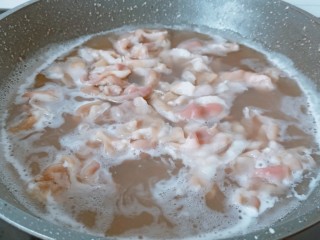 金针菇牛肉卷,锅里加适量的清水，水开下肥牛焯水。