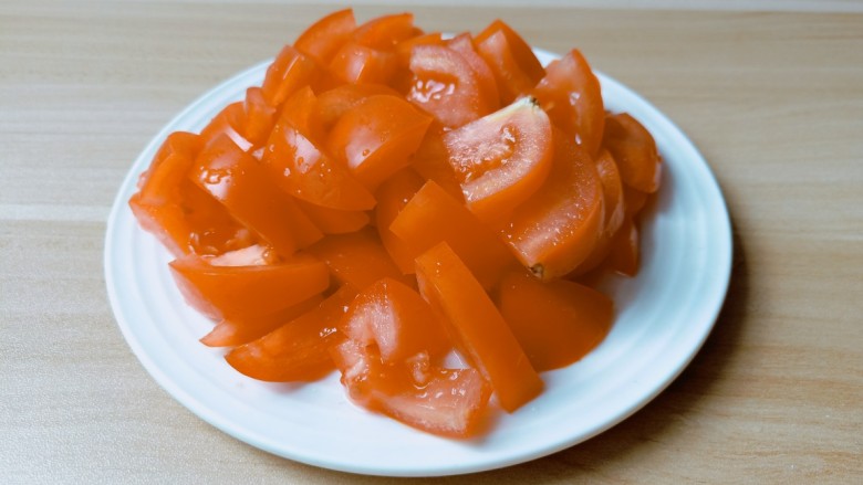 金针菇牛肉卷,<a style='color:red;display:inline-block;' href='/shicai/ 59'>番茄</a>清洗好对半切开，然后切成薄片。