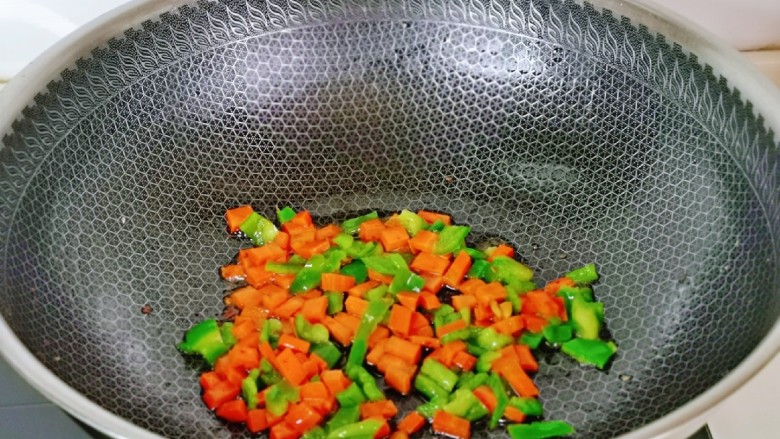 醋泡花生米,锅中留底油，加入胡萝卜丁青椒丁快速翻炒1分钟，盛出晾凉。