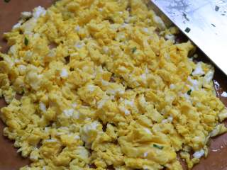 韭菜鸡蛋粉丝包子,鸡蛋用油锅煎熟，煎熟以后取出来，倒在砧板上，用刀切碎。