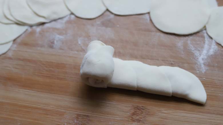 玫瑰花煎饺,将饺子皮对折起来，然后从一端卷起来即可，卷好以后就成玫瑰花了，可以用手稍微整理下细节。