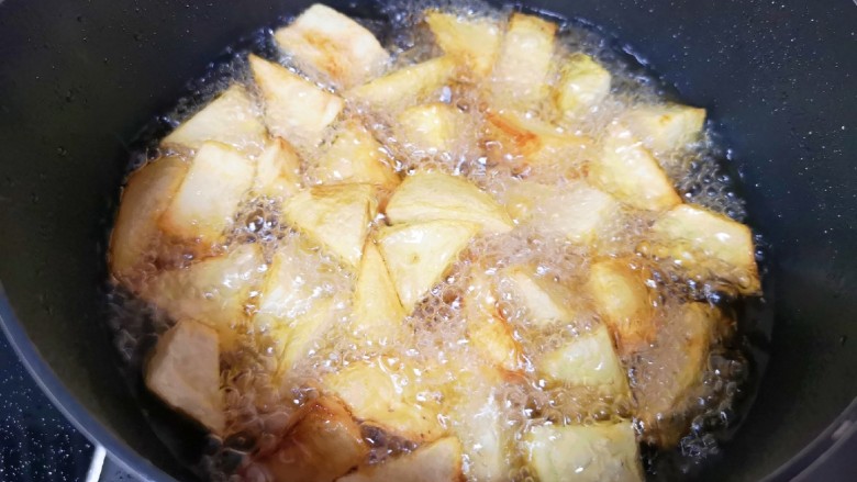 麻辣干锅鸡,土豆块用厨房用纸吸一下表面的水分，炸锅内倒入多一些食用油烧热，下入土豆块炸至金黄色捞出备用。