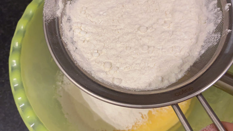 草莓蛋糕,将混合好的面粉和玉米淀粉过筛到蛋黄盆里，用手动打蛋器搅打均匀
