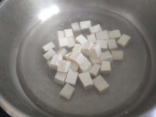 韭菜炒豆腐,锅中放入适量清水烧开，放入豆腐烧几分钟