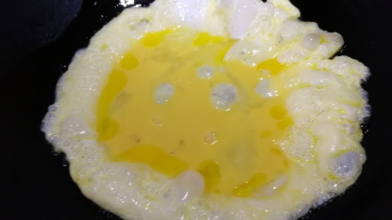 番茄炒蛋,倒入蛋液，把四周起鼓的炒蛋推到一侧。