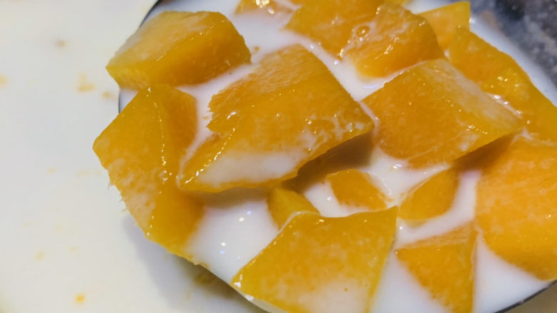 芒果西米捞,微波炉已经热好牛奶芒果粒，搅拌一下，热芒果的目的是为了融合牛奶和芒果的味道，有点像芒果汁加牛奶；