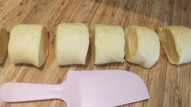 红豆沙拉丝面包,在揉成原先大小切成剂子。