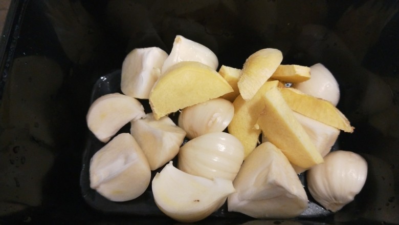 酸菜炖羊肉,锅中倒入大蒜头切瓣。