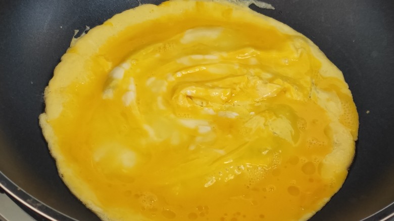菠菜木耳炒鸡蛋,锅内热油倒入蛋液