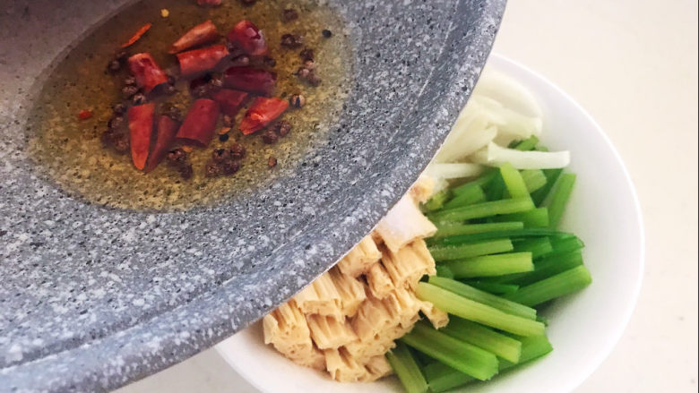 芹菜拌腐竹,趁热把做好的料油到入菜碗里