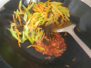 芹菜炒木耳,把菜铲到一边，放入少量植物油，放入一勺郫县豆瓣酱，翻炒出红油