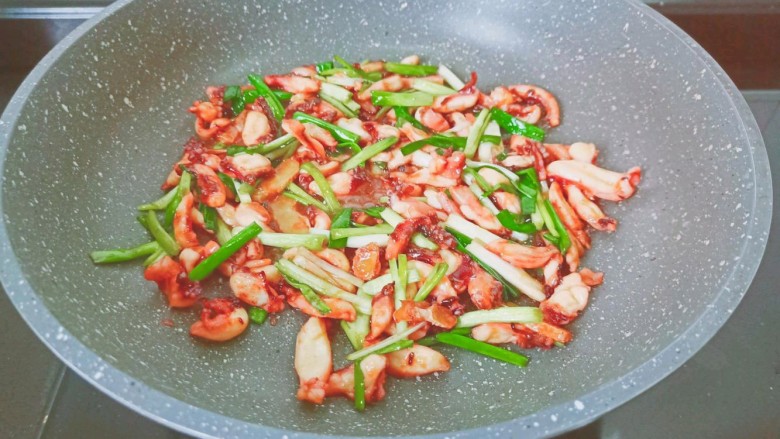 香辣鱿鱼须,起锅前加入小葱煸炒关火成盘。