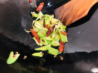 蒜香小龙虾,锅内重新倒入底油放入大葱、花椒、麻椒、干辣椒炒香。
