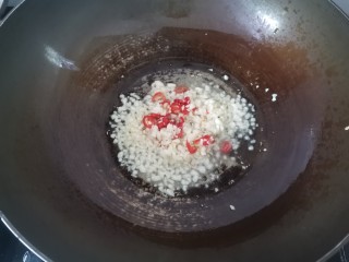 清蒸蛏子,锅里加入适量的油，油热倒入蒜末小米辣炒出香味