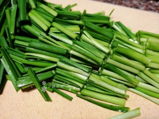 韭菜炒扇贝,将韭菜拆洗干净切成小段。