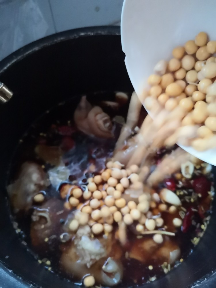 黄豆炖猪蹄,最后将黄豆放入锅内，我们就要将猪蹄放入高压锅。进行炖煮啦！