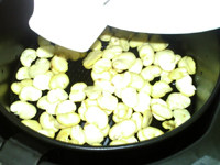 油炸蚕豆,将拌好油的蚕豆瓣倒入炸锅网篮，铺开，推入炸锅