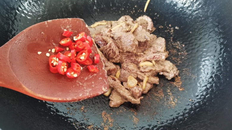 西兰花炒牛肉,炒至牛肉变色放入小米辣继续煸炒