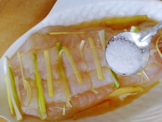 清蒸龙利鱼,均匀洒上半小勺盐。