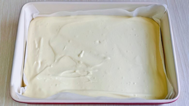 棉花蛋糕&不开裂不回缩方子,烤盘中垫一张油纸，再倒入蛋糕糊，刮平整。