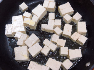豆腐炒鸡蛋,倒入豆腐块儿，酱豆腐煎焦黄。